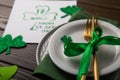 St Patrick`s Day party table setting decorated with green leprechaun on wooden background