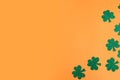 St. Patrick`s Day side border paper shamrocks on orange background. Royalty Free Stock Photo