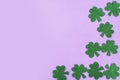 St. Patrick`s Day side border paper shamrocks on purple background. Royalty Free Stock Photo