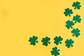 St. Patrick`s Day side border paper shamrocks on yellow background. Royalty Free Stock Photo