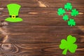 St. Patrick`s Day theme colorful horizontal banner. Green leprechaun hat and shamrock leaves on brown wooden background. Felt cra