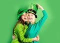 St Patrick's Day. Two girls in a wig and a cap in bar. Celebrating concept. Having fun.