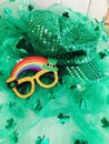 St Patrick's outfit, tutu, sparkly hat, and rainbow glasses,