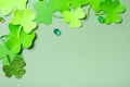 St. Patrick's Day minimalistic concept. Paper clover leaves on colored background with copy space