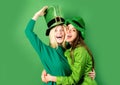 St Patrick& x27;s Day. Two girls in a wig and a cap in bar. Celebrating concept. Having fun.