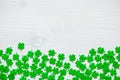 St Patricks Day background with green quatrefoils on white background, free space for festive St Patrick text