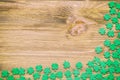 St Patricks Day background, bright green quatrefoils on texture wooden surface, free space for St Patrick text