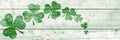 St Patricks day background. Shamrocks over a light green wood background. Decoration for St. Patrick\'s Day