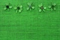 St Patricks Day border of paper shamrocks on green burlap Royalty Free Stock Photo