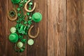St Patricks Day border of shamrocks beads and coins over a rustic wood background Royalty Free Stock Photo