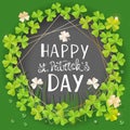 St. Patricks Day card. Wreath with clover leaves, coins and gold geometry frames on green background for greeting Royalty Free Stock Photo