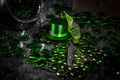 Shamrocks, coins, leprechaun hat and silver pot on vintage style wood background.