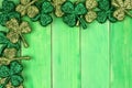 St Patricks Day corner border of shamrocks over green wood Royalty Free Stock Photo