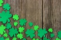 St Patricks Day corner border of shamrocks over rustic wood Royalty Free Stock Photo