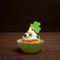 St. Patricks Day Cupcake decorated with Shamrocks isolated on Dark Rustic Wood Table and Background with copy space Royalty Free Stock Photo