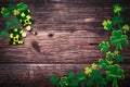 St Patricks day, festive leprechaun hat and green Shamrocks on wooden Royalty Free Stock Photo