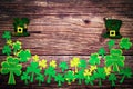 St Patricks day, festive leprechaun hat and green Shamrocks on wooden Royalty Free Stock Photo