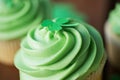 Close up of green cupcake with shamrock decoration