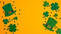 St. Patricks Day frame of shamrock leaf clovers, Irish elf hats and confetti on orange background. Flat lay, top view. Saint Royalty Free Stock Photo