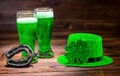 St Patricks day with glasses of green beer, leaf clover, light l Royalty Free Stock Photo