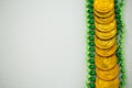 St Patricks Day gold chocolate coin and beads Royalty Free Stock Photo