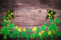 St Patricks Day, golden coins, festive hat and green Shamrocks with saint patricks day lettering on wooden Royalty Free Stock Photo