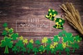 St Patricks Day, golden coins, festive hat and green Shamrocks with saint patricks day lettering on wooden Royalty Free Stock Photo