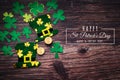St Patricks Day, golden coins, festive hat and green Shamrocks with saint patricks day lettering on wooden Royalty Free Stock Photo