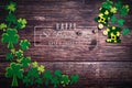 St Patricks Day, golden coins, festive hat and green Shamrocks with saint patricks day lettering on wooden Royalty Free Stock Photo