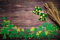 St Patricks day, golden coins, festive hat and green Shamrocks on wooden Royalty Free Stock Photo