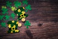 St Patricks day, golden coins, festive hat and green Shamrocks on wooden Royalty Free Stock Photo