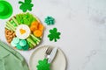 St Patricks day holiday celebration with charcuterie board and party decorations on bright background.