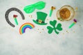 St Patricks day holiday concept with lucky charms, shamrock and beer glass on rustic background. Top view from above