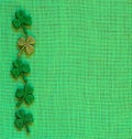 St. Patricks Day or Irish Green Shamrocks on Burlap Linen Background with copy space. It`s square with a trendy flat layout