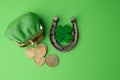 St. Patricks day, lucky charms. Horesechoe and shamrock on green background Royalty Free Stock Photo