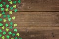 St Patricks Day shamrocks side border over rustic wood