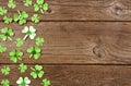 St Patricks Day side border of paper button shamrocks, top view on a wood background with copy space Royalty Free Stock Photo