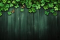 St Patricks Day side border of paper shamrocks over a dark green wood background Royalty Free Stock Photo