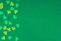 St Patricks Day shamrocks side border over a green background