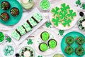 St Patricks Day dessert table scene over white wood