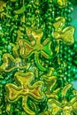 St Patricks Day vertical background of shiny green beads with shamrocks