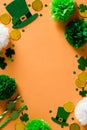 St Patricks Day vertical banner design with leprechaun hats, gold coins, confetti, decorations on orange background. Happy Saint