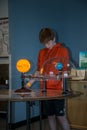 13 year old boy checks out an exhibit about how the earth and sun work together at the science museum