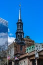 St. Paul`s Chapel of Trinity Church Wall Street in the background is Seven World Trade Center with clouds reflected in the window Royalty Free Stock Photo