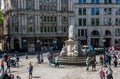 Tourists gathered outside St Pauls Cathedral on sunny day with Victoria Statue