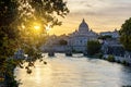 St. Peter`s basilica dome and St. Angel bridge over Tiber river at sunset in Rome, Italy Royalty Free Stock Photo