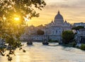 St. Peter\'s basilica dome and St. Angel bridge over Tiber river at sunset in Rome, Italy Royalty Free Stock Photo