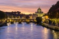 St. Peter`s basilica dome and Victor Emmanuel II bridge over Tiber river at sunset in Rome, Italy Royalty Free Stock Photo