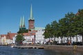 St. Peter`s Church and st. marys church with traditional houses on the trave river, luebeck, germany