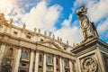 St. Peter`s square, Vatican City, Roma. Low angle view of the statue of St. Peter with the front of the Basilica in the background